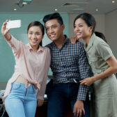 Young Vietnamese business team taking selfie in meeting room
